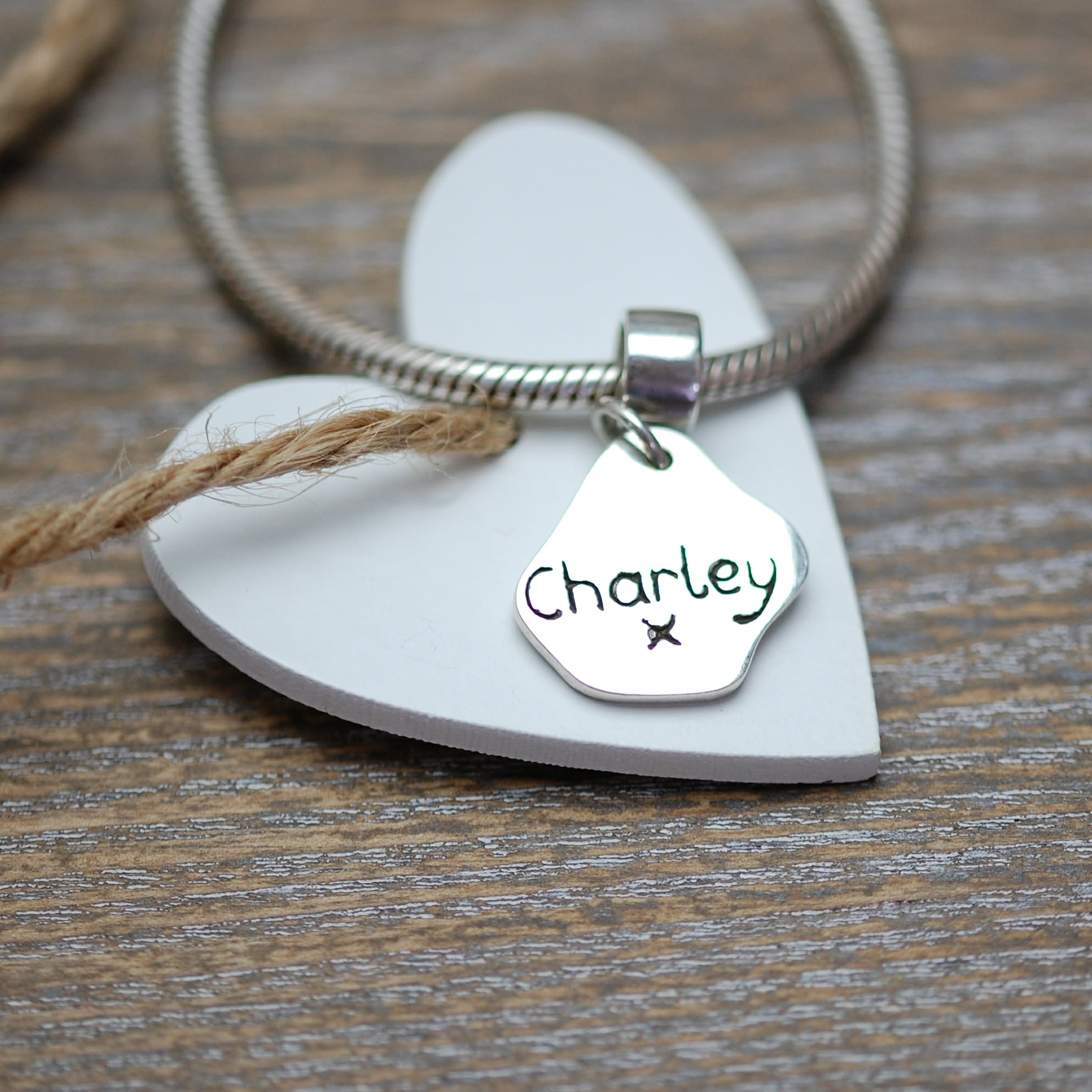 Inscription on the back of silver paw print charm