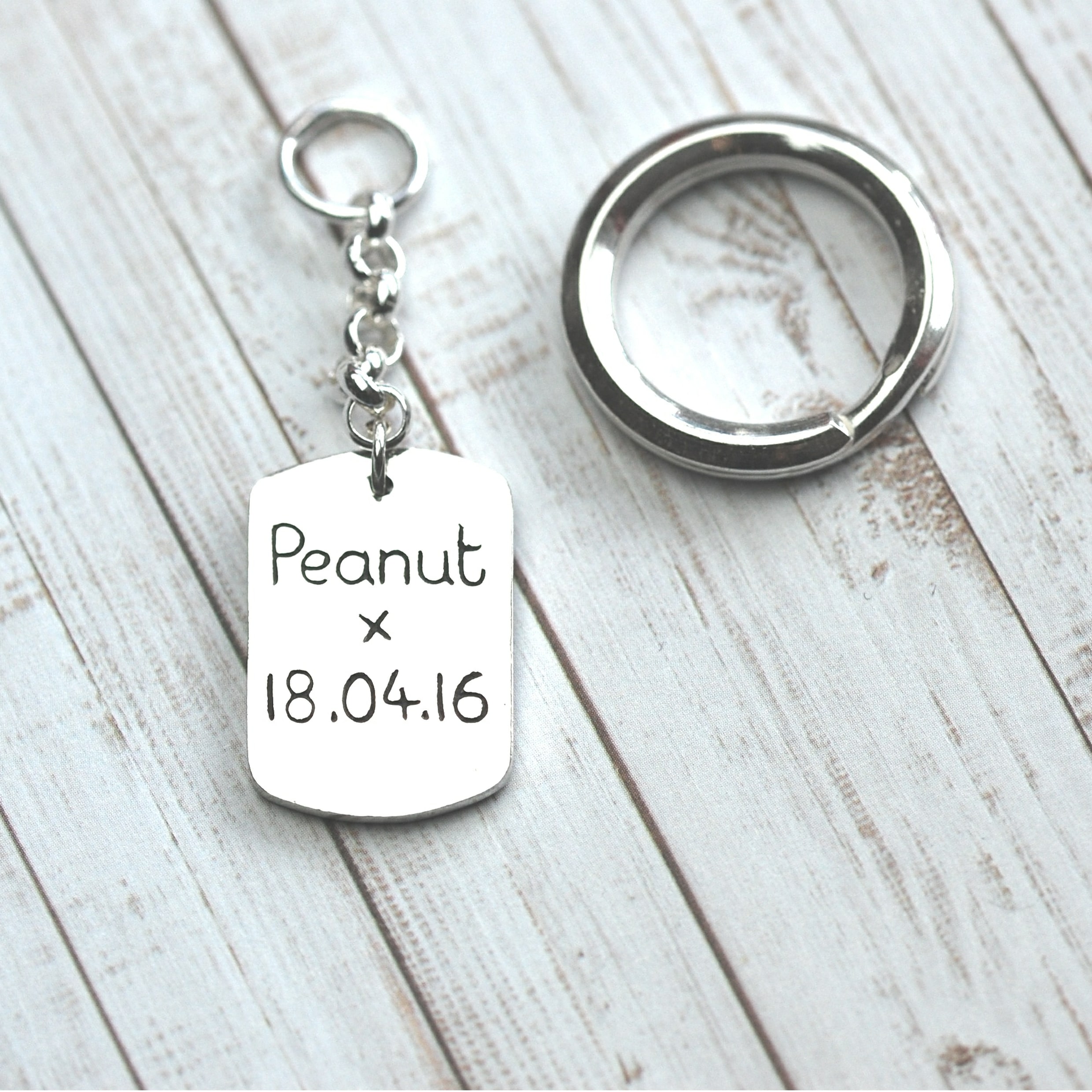 Name and date inscribed on back of paw print keyring