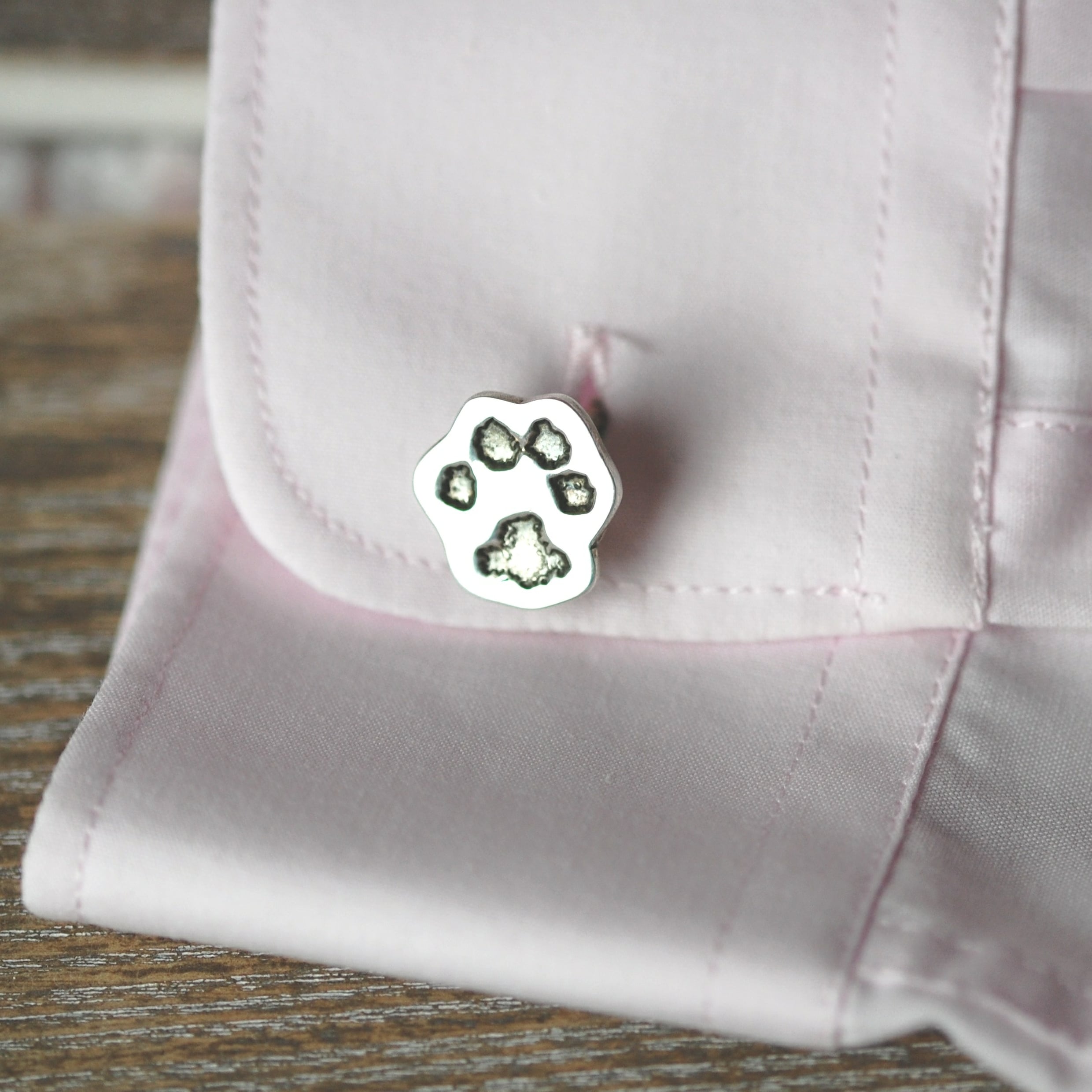 Silver cufflink cut out in the shape of your pet's unique paw print