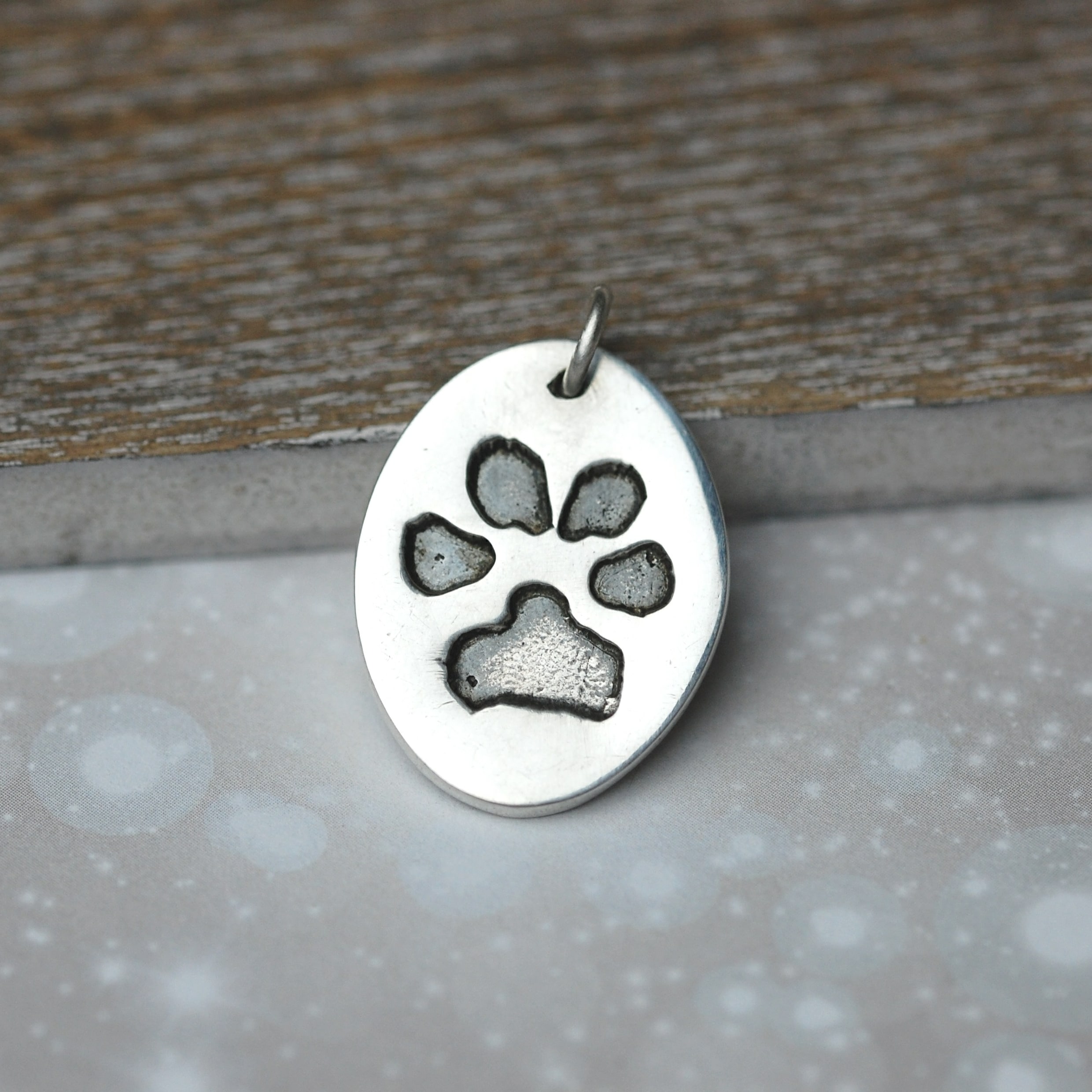 Silver oval charm showcasing your animal's unique paw print