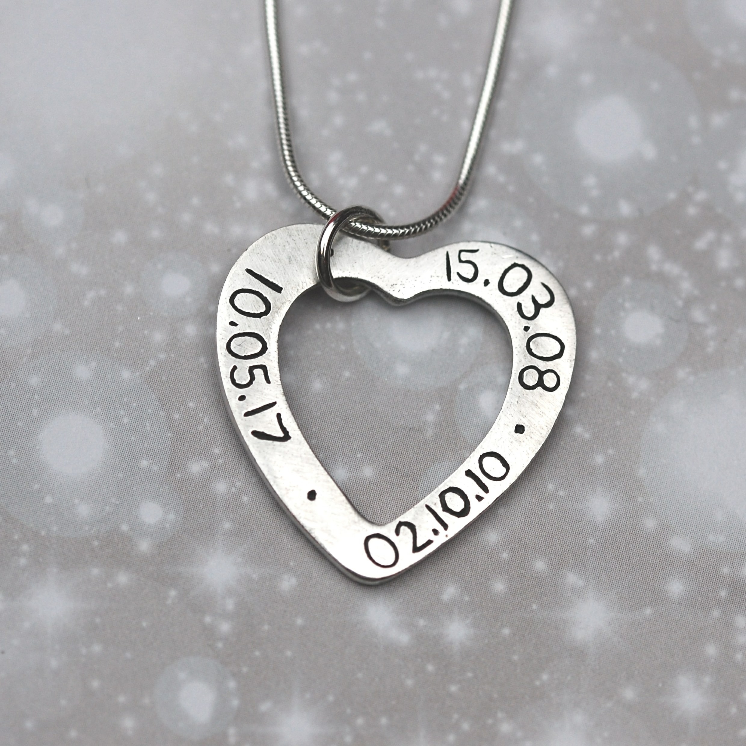 Inscription on the back of silver heart shaped name charm