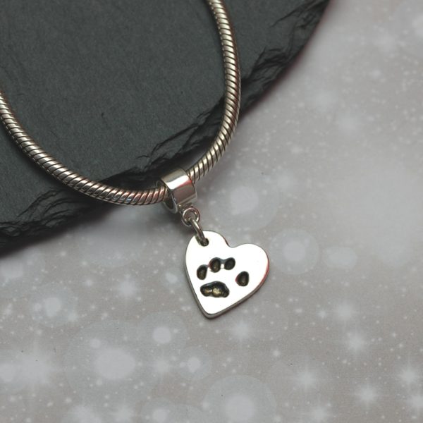 Small silver paw print charm with charm carrier