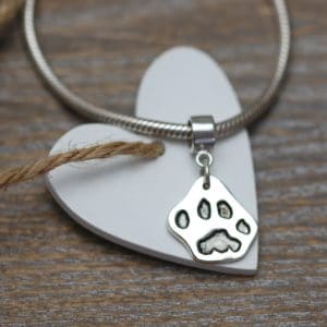 Small silver cut out paw print charm with charm carrier