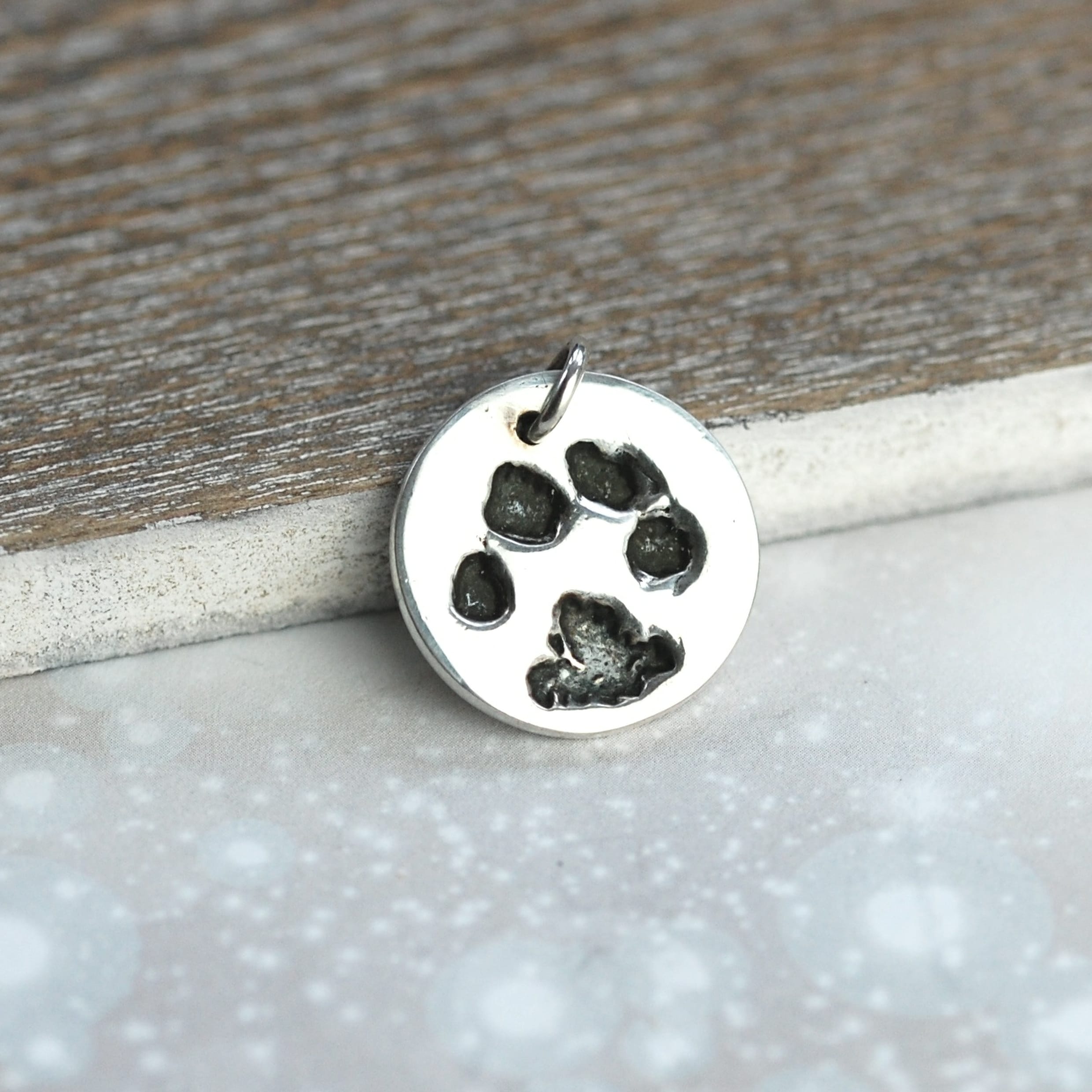 Small sterling silver charm with your pet's unique paw print and name