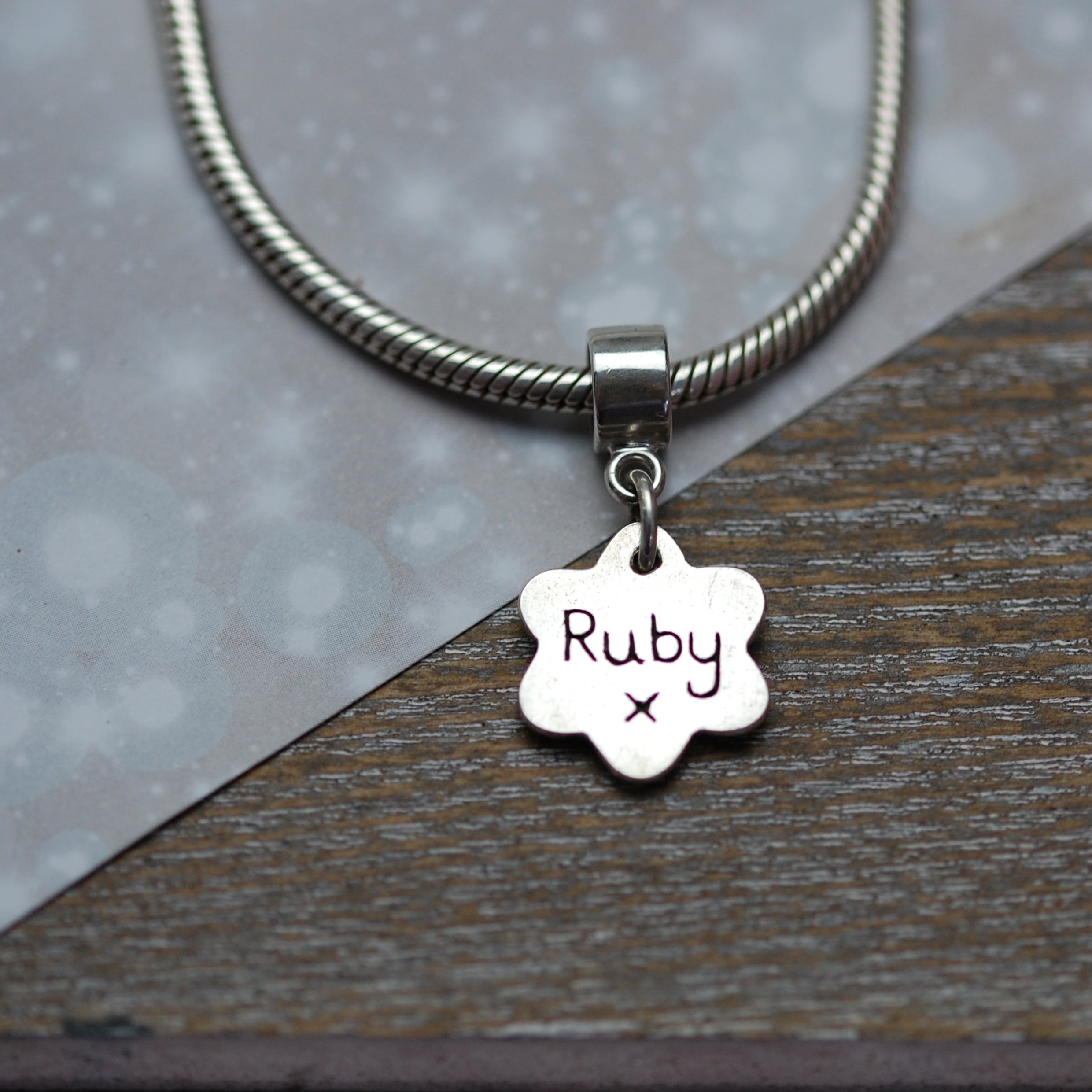 Inscription on the back of raised paw print charm