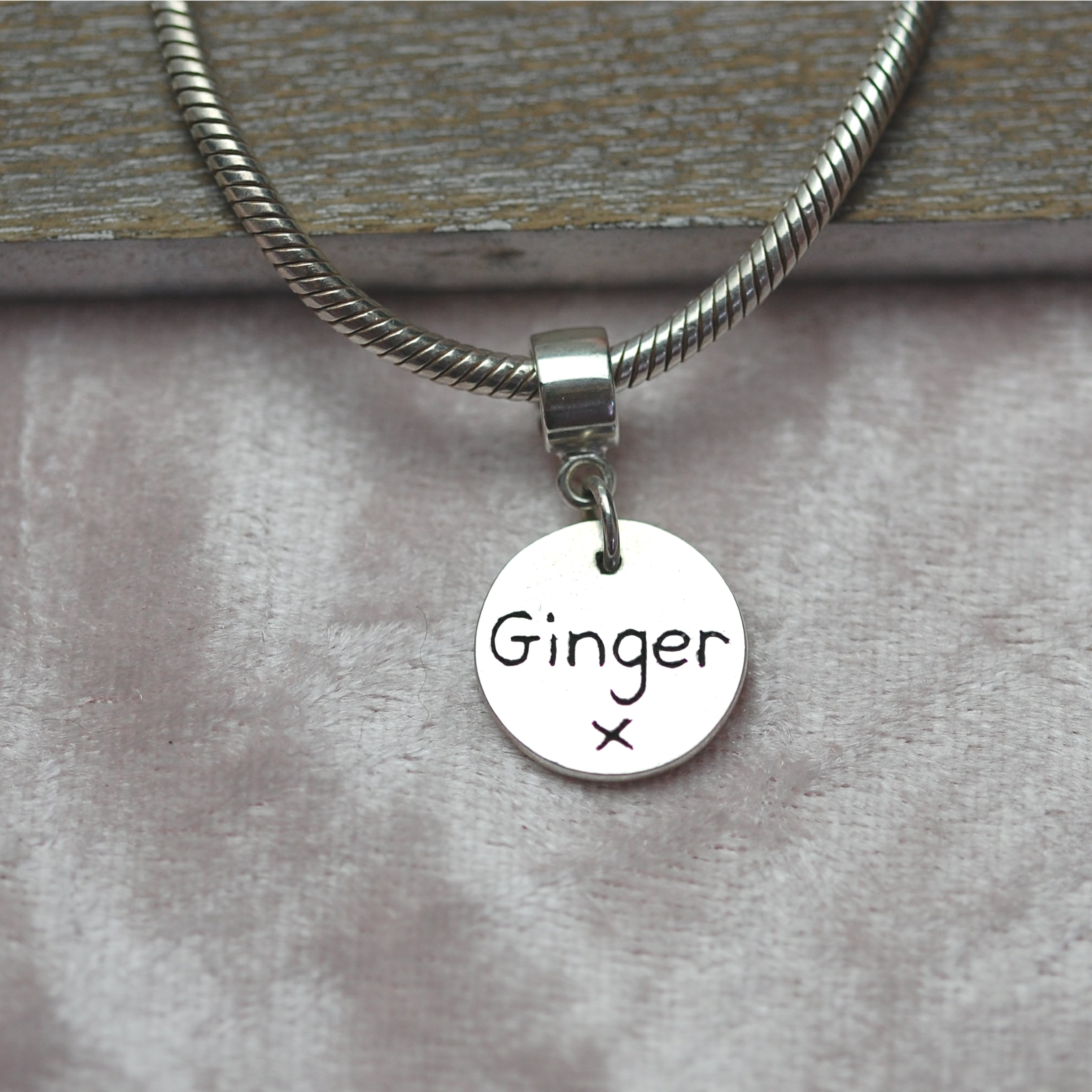 Inscription on the back of raised paw print charm with charm carrier