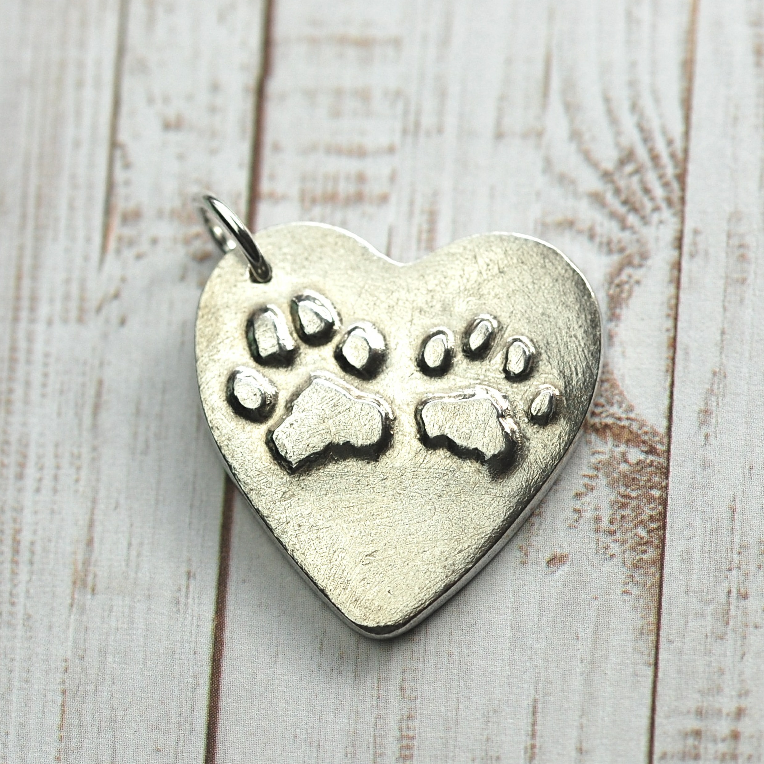 Sterling silver heart with your pet's raised paw prints