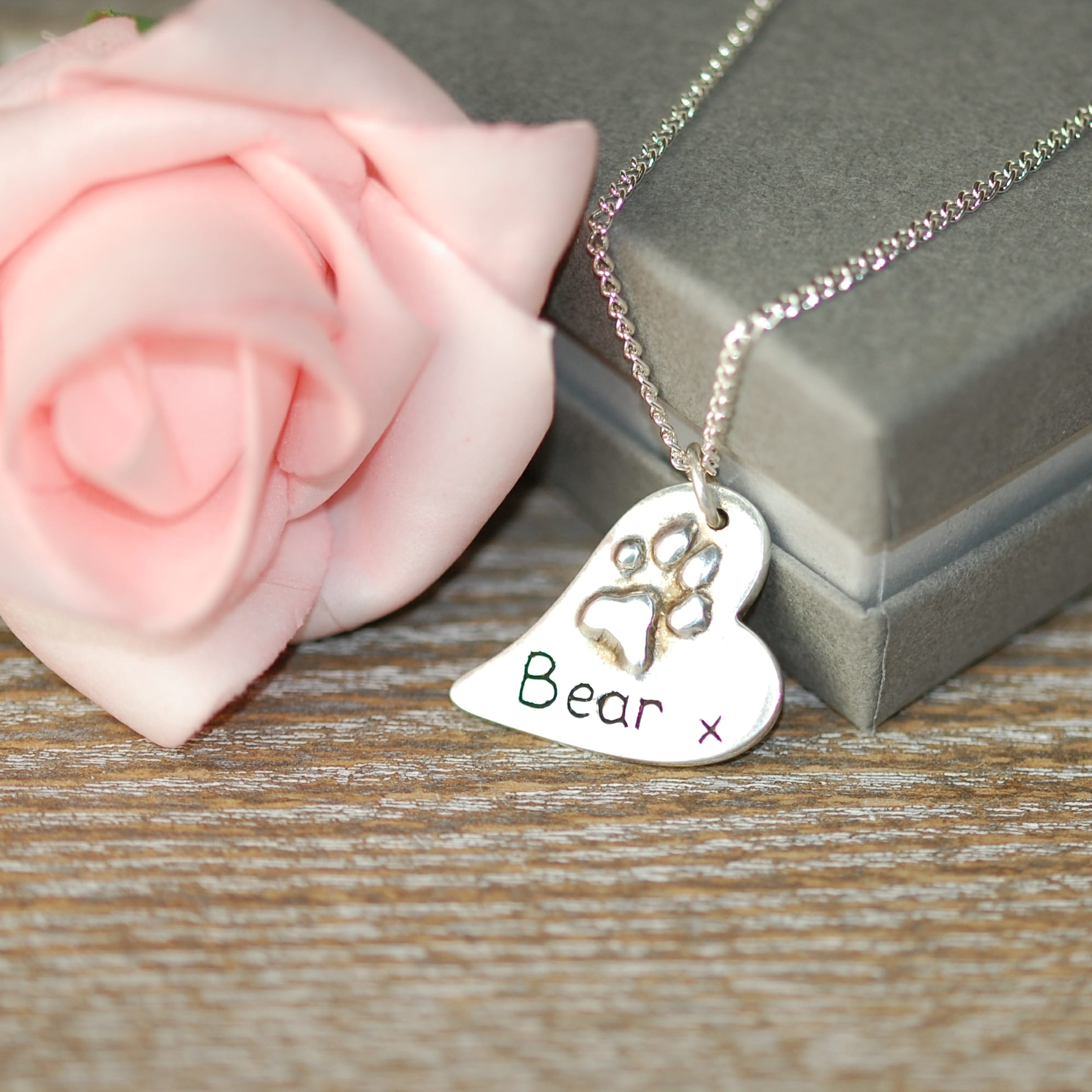 Regular raised paw print charm made from silver clay