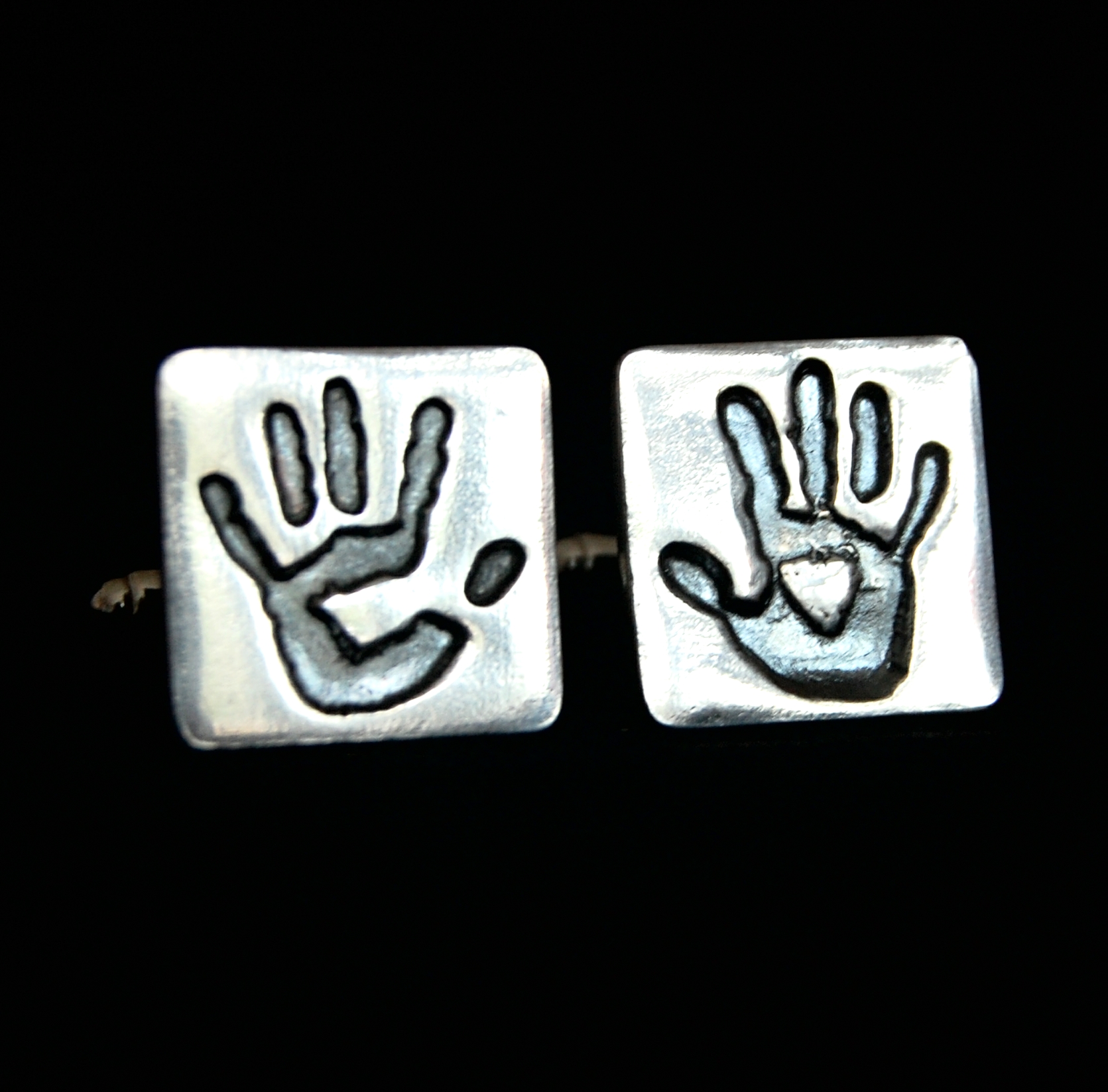 Square silver cufflinks with adult handprints. Name hand inscribed on the back.