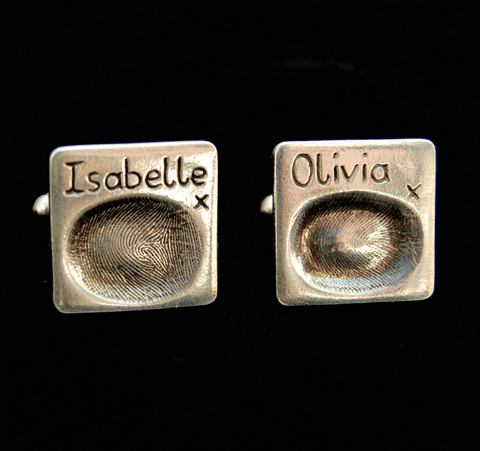 Square shaped silver fingerprint cufflinks with names hand inscribed above the prints.