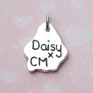 Inscription on the back of paw print charm