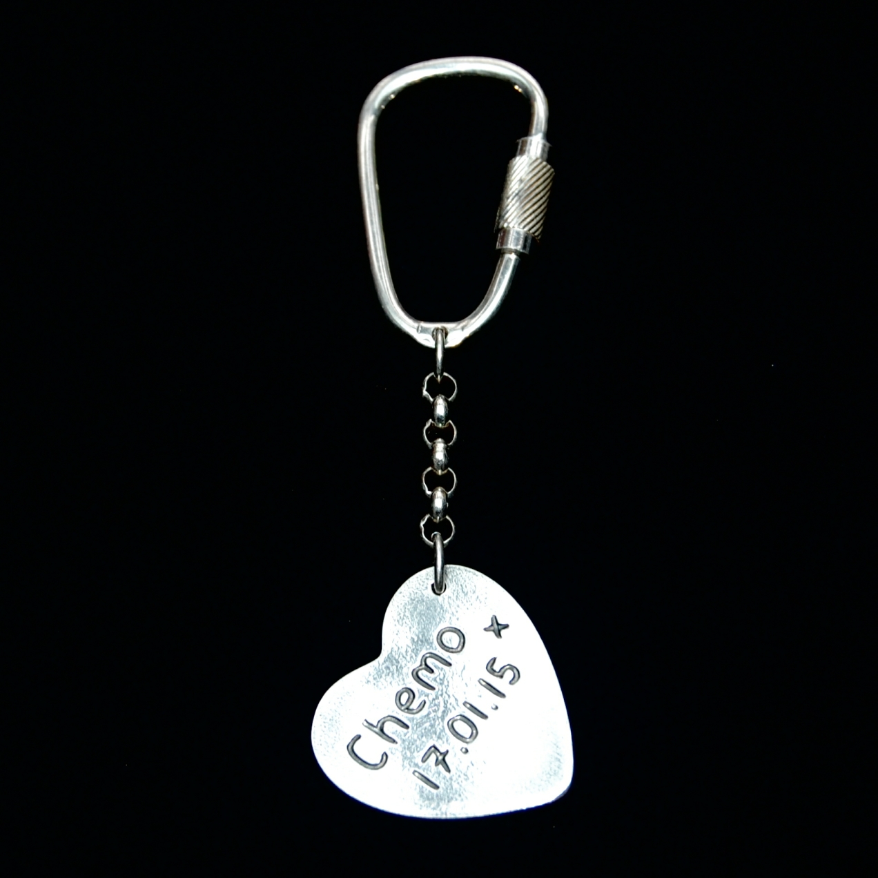 Name and special date hand inscribed on the back of a large heart keyring.