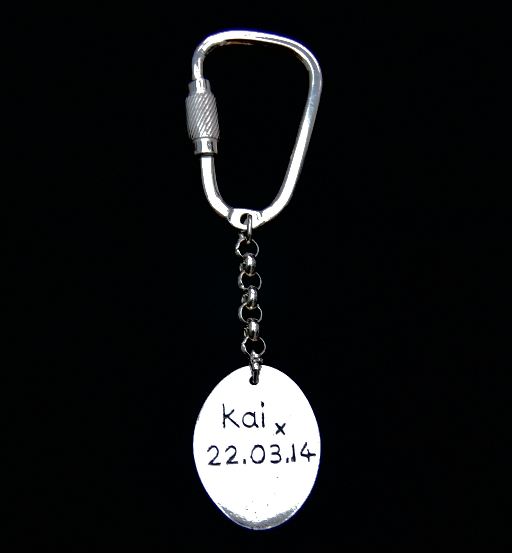 An inscription on the back of an oval 'say it in silver' keyring.