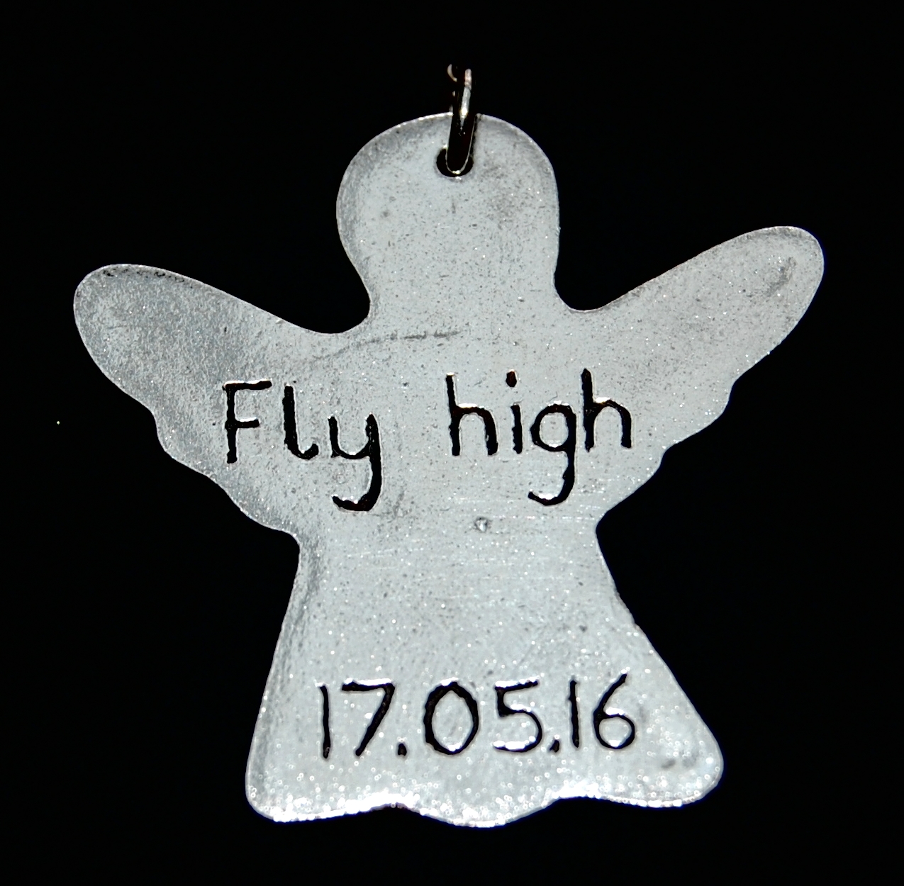 Inscription on the back of a silver angel footprint charm.