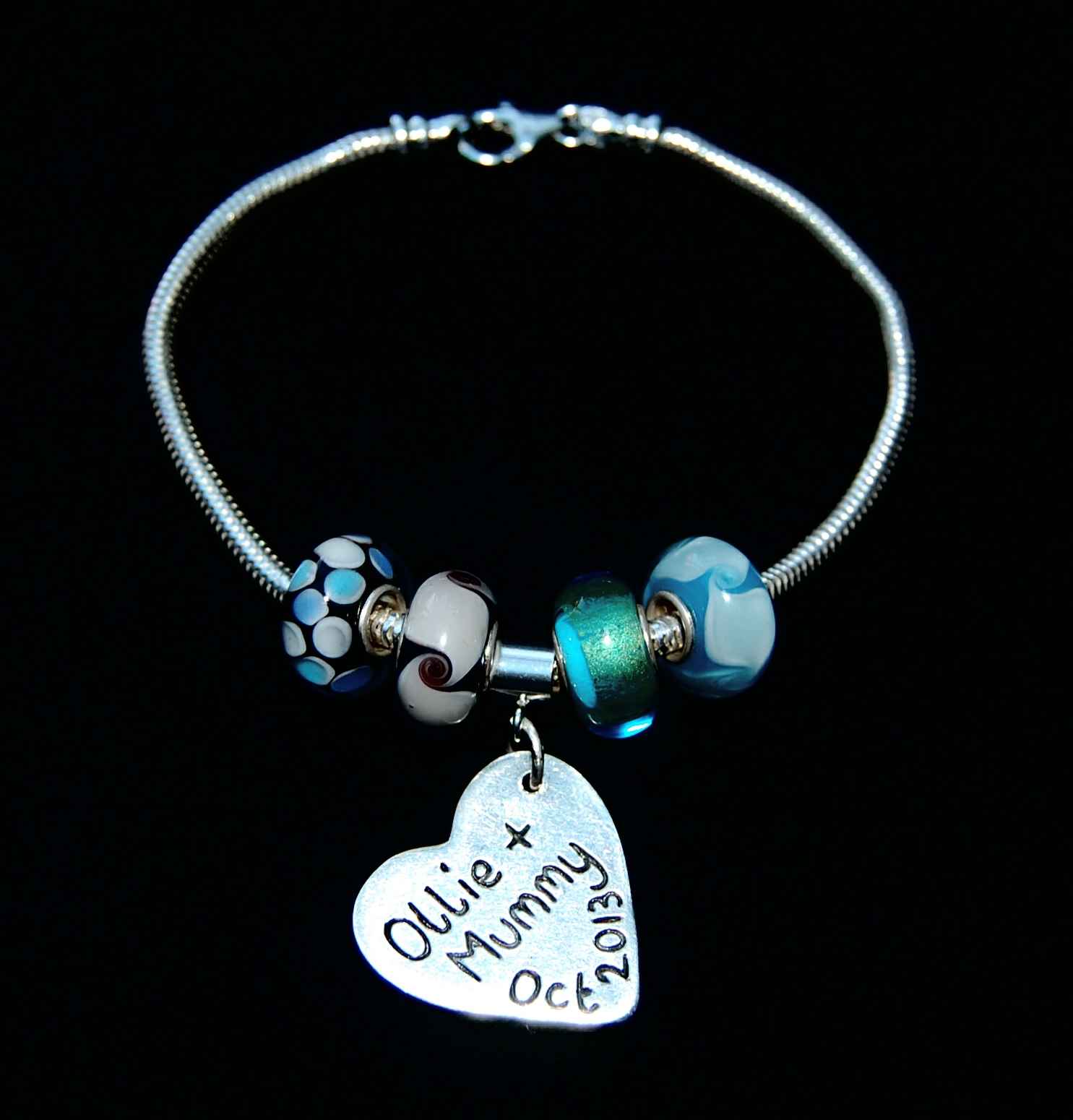 Personalised message on the back of a doodles and signature charm. Bracelet can be purchased separately.