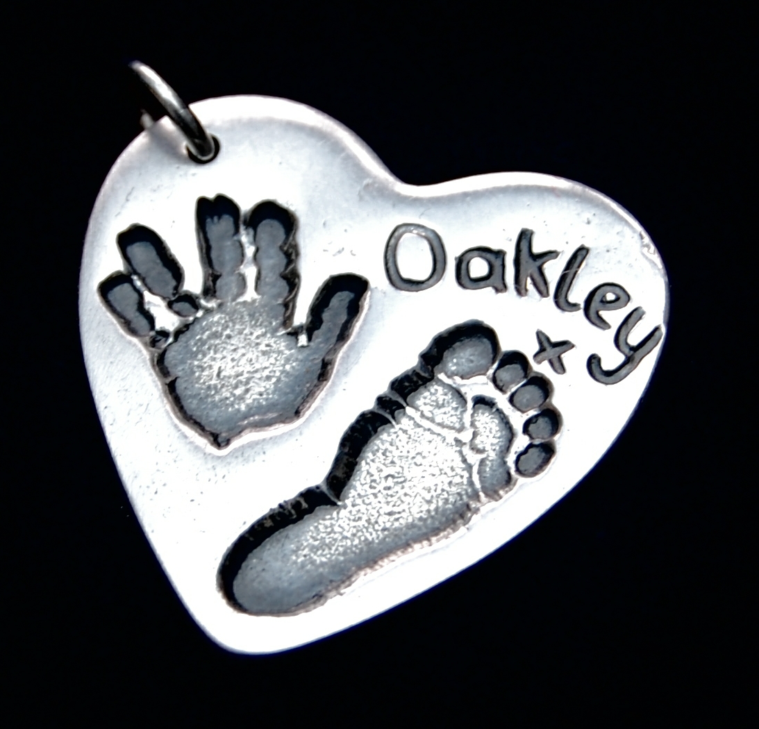 Large silver heart charm with hand & footprint and hand inscribed name.