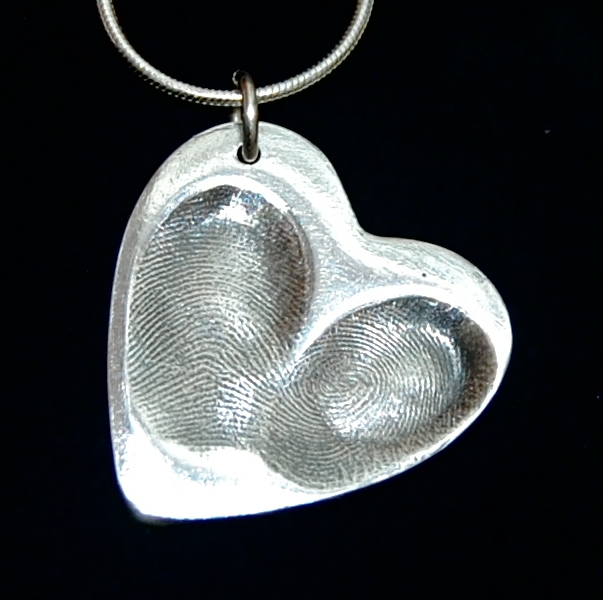 Large heart shaped silver fingerprint charm with 2 fingerprints side by side. Names hand inscribed on the back.