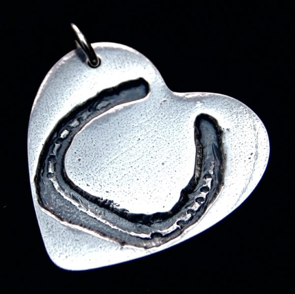 Large silver heart charm with your horse's unique shoe imprint.