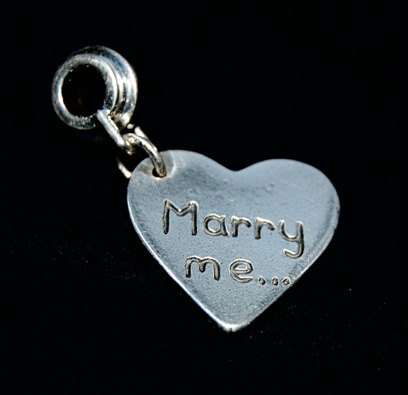 Regular silver heart charm with your chosen message hand inscribed. Presented on a charm carrier, ready to add to your bracelet or necklace.