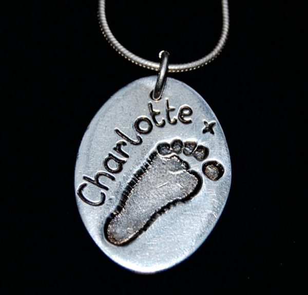 Regular silver oval footprint charm with name hand inscribed alongside the print. Silver snake chain can be purchased separately.