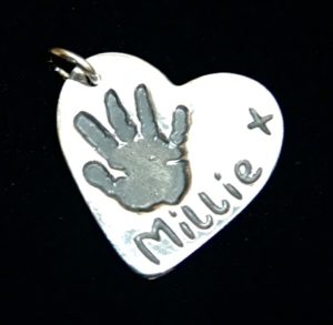 Regular silver heart handprint charm with name hand inscribed on the back.