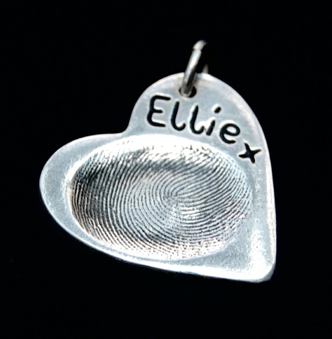 Regular heart shaped silver fingerprint charm with fingerprint and name inscribed on the front.