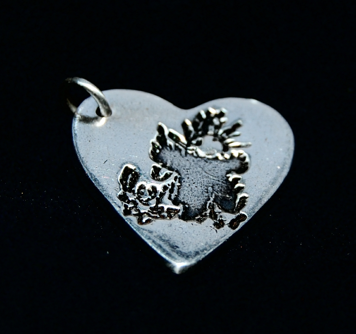 Regular silver heart charm showcasing your child's precious drawing.