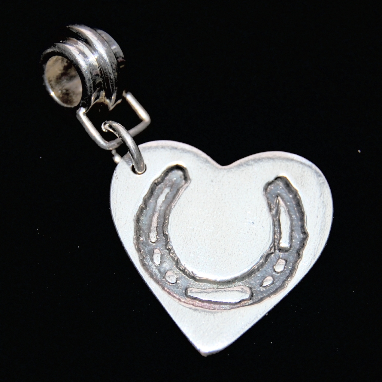 Regular silver heart horse shoe charm with charm carrier, ready to add to your bracelet.
