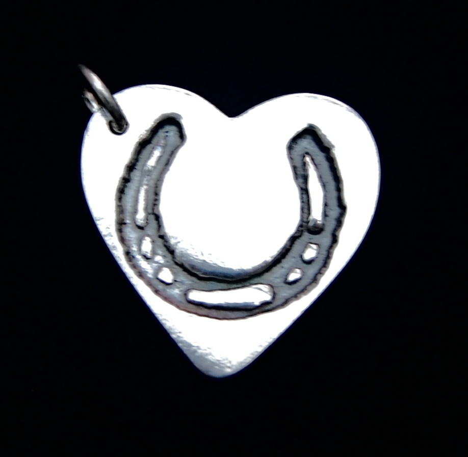 Regular silver heart charm with your horse's shoe imprint. Name inscribed on the back.