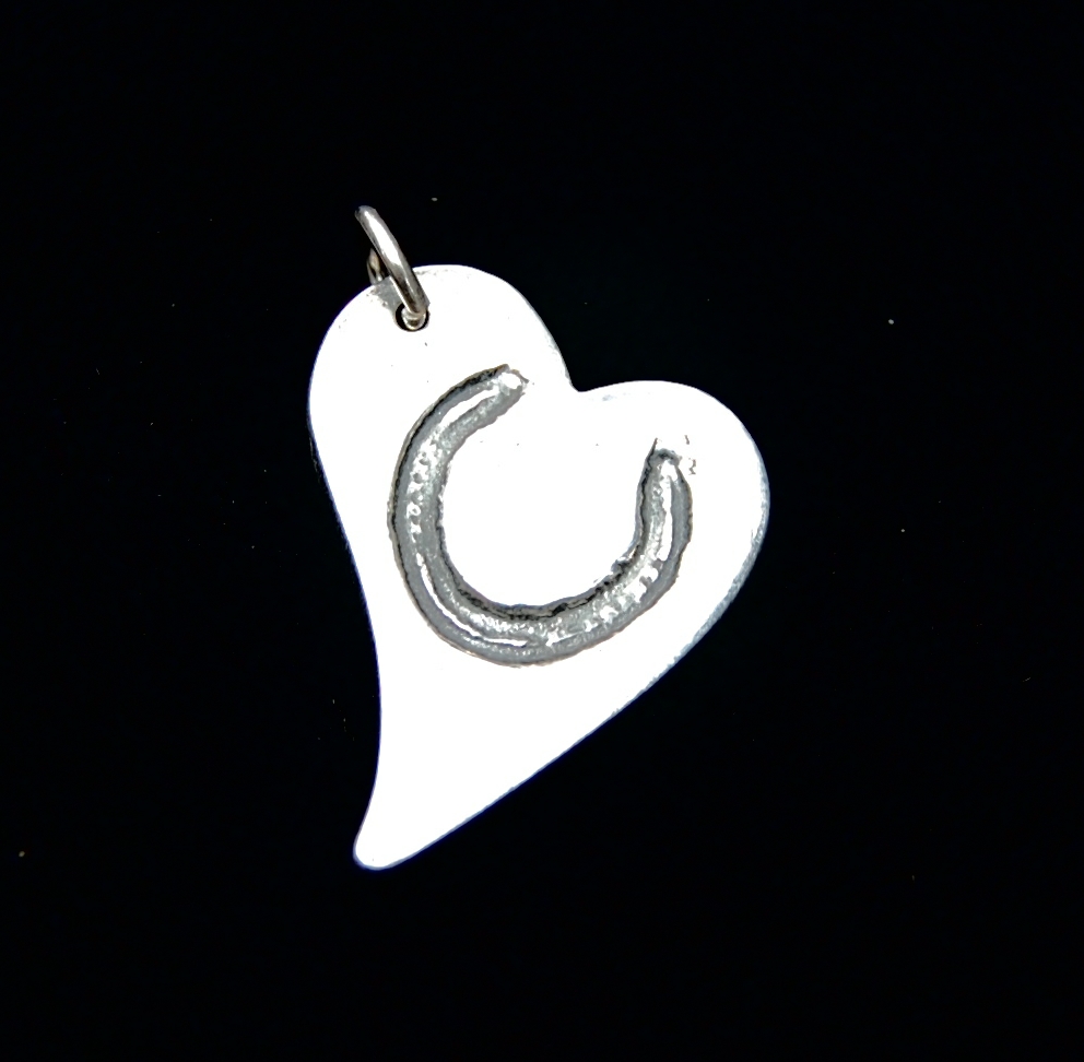 Regular silver curved heart horse shoe charm with name inscribed on the back.