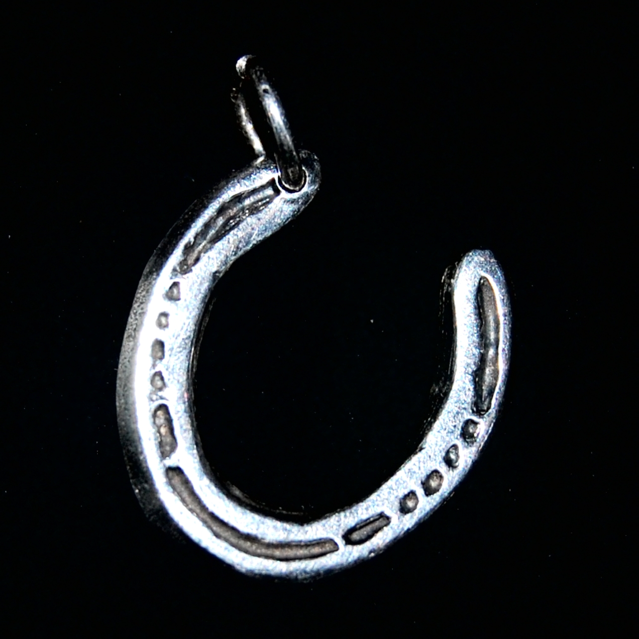 Regular horse shoe cut out charm with initial inscribed on the back.