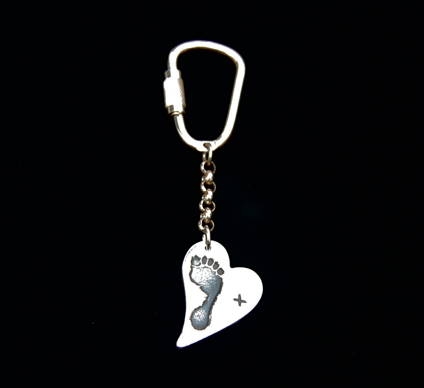 Regular silver curved heart footprint keyring inscribed with a simple but effective kiss on the front and name on the back.