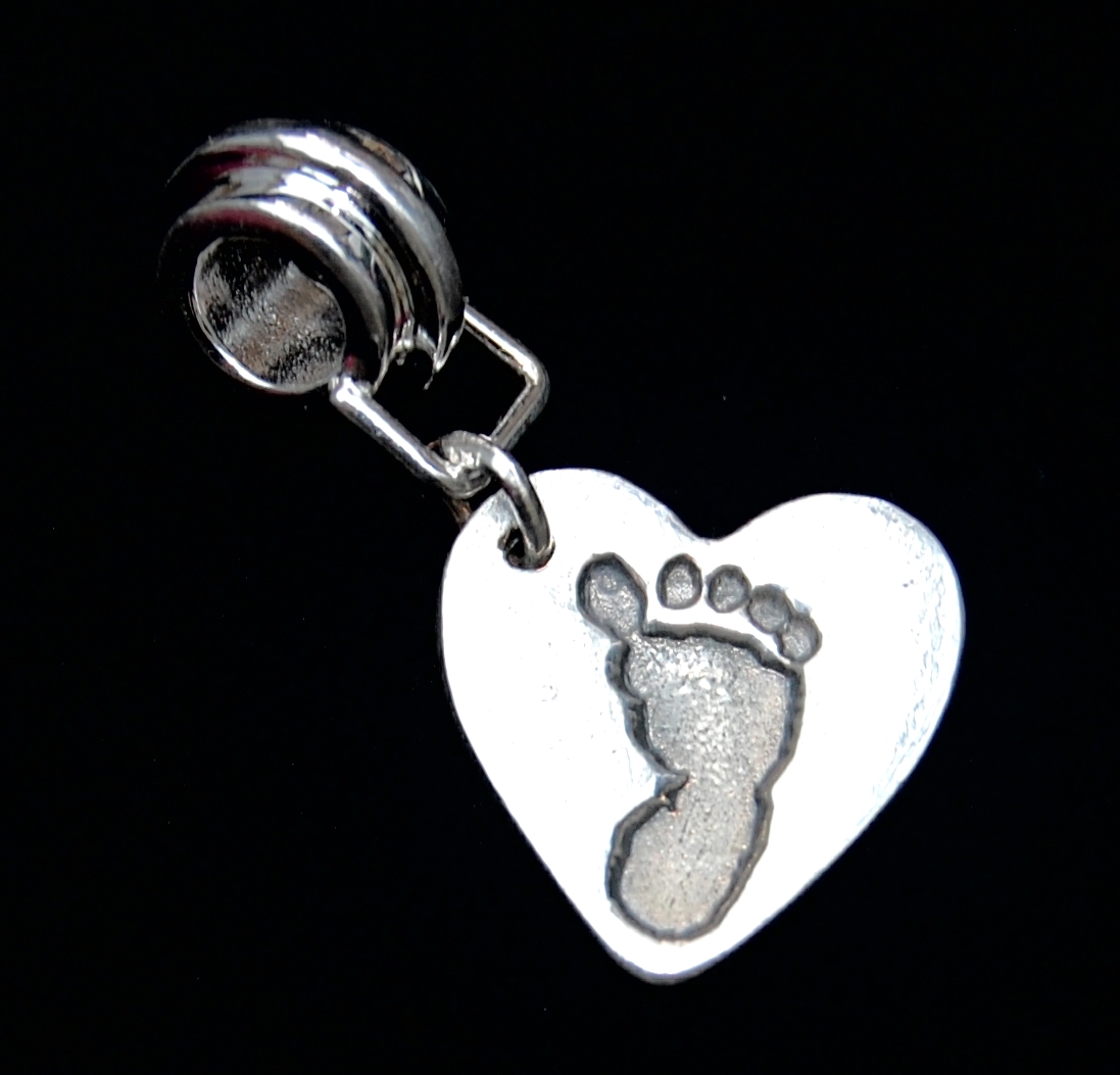 Small silver heart footprint charm with charm carrier.