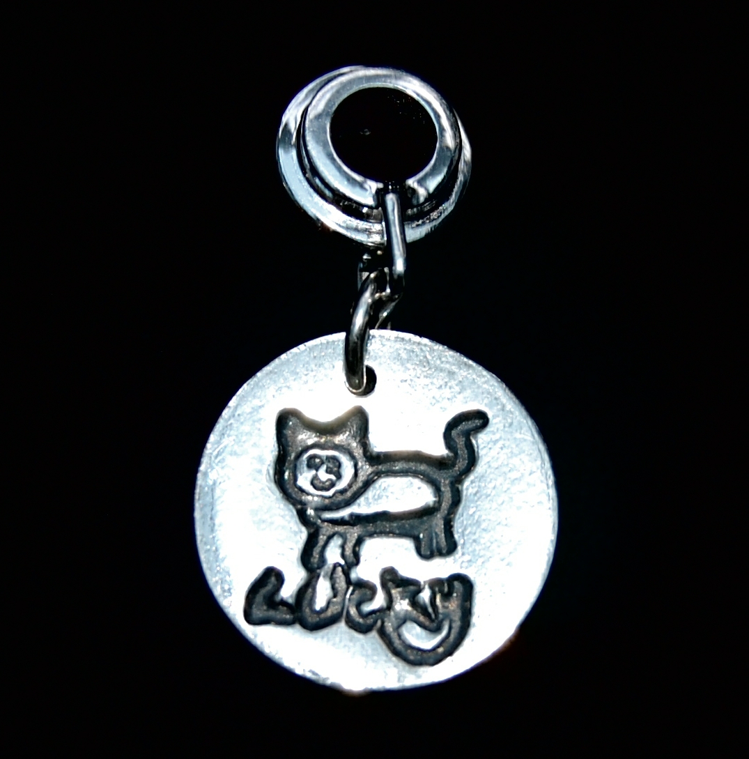 Small silver circle charm featuring your little one's first drawing and/or writing. Presented on a charm carrier ready to add to your bracelet.
