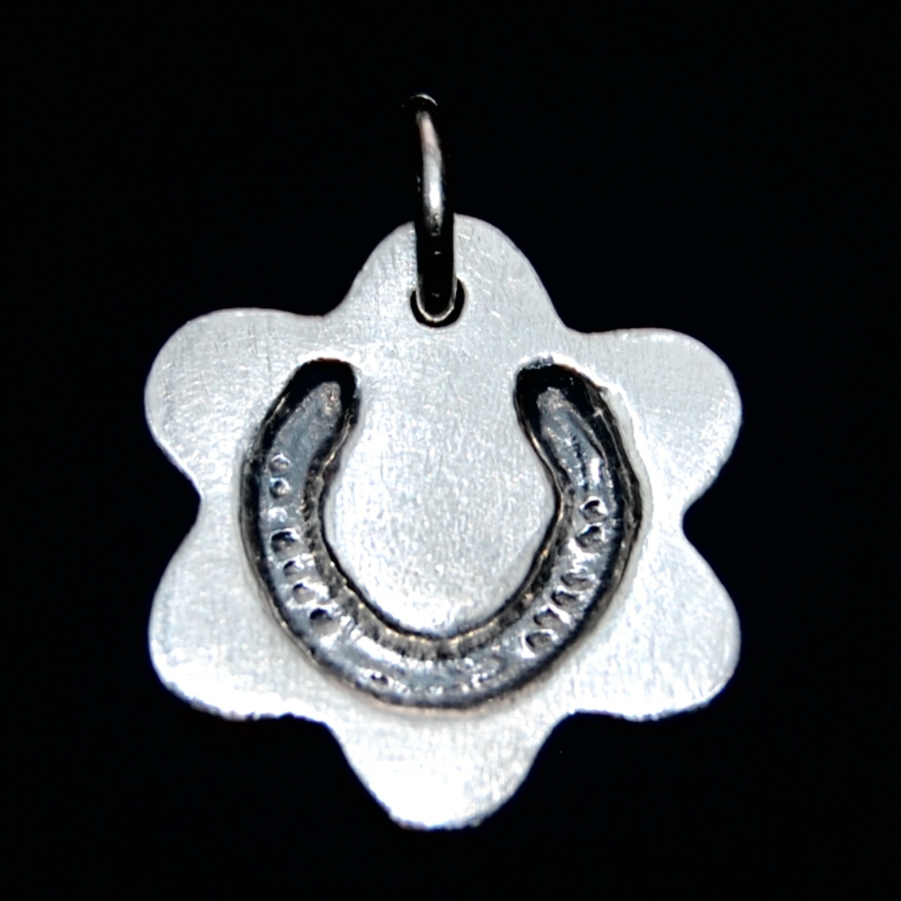 Small silver flower charm with your horse's shoe imprint.
