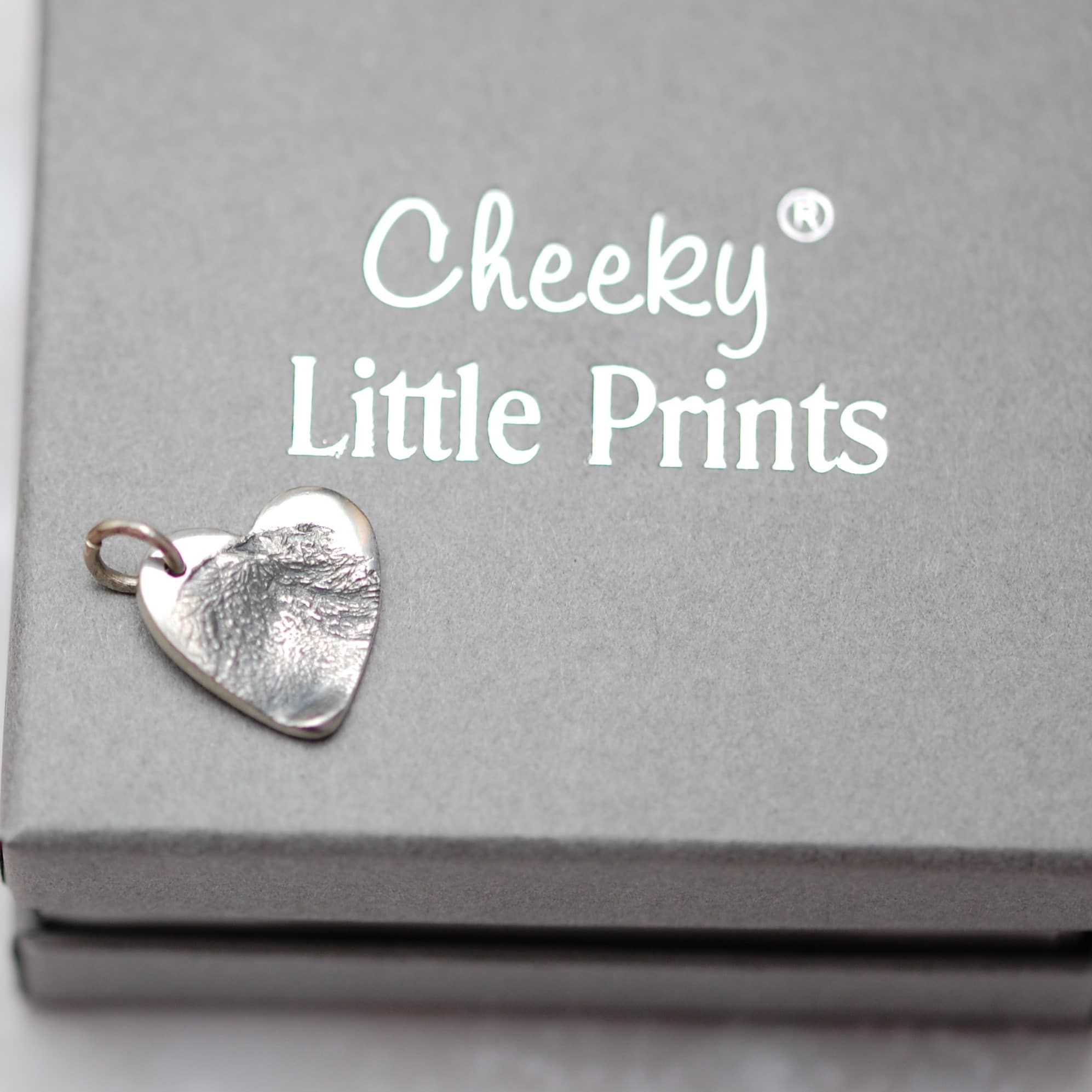 Small silver paw pad print charm