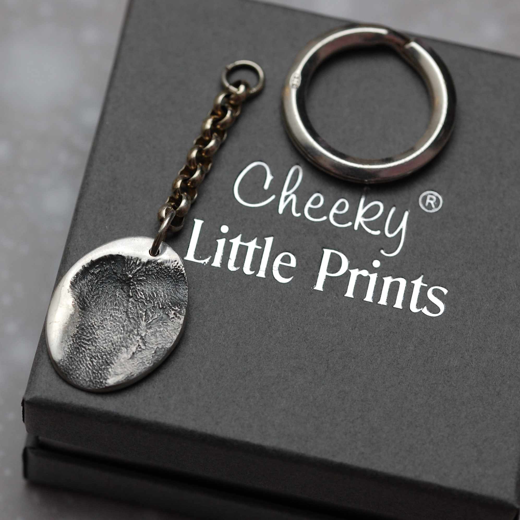 Sterling silver paw pad print keyring created from silver clay