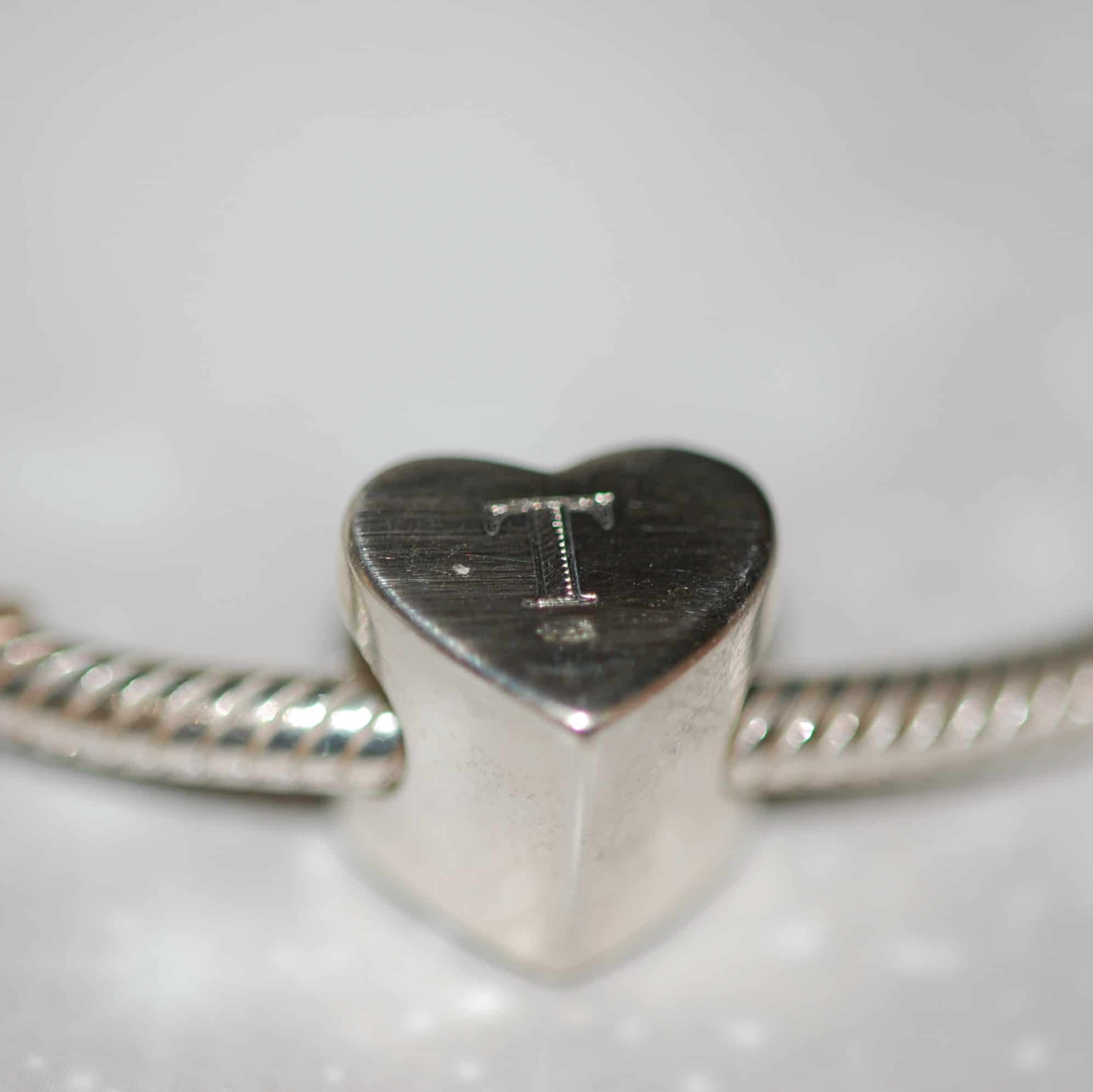 Initial engraved on the back of silver heart charm bead with pet fur or cremation ashes