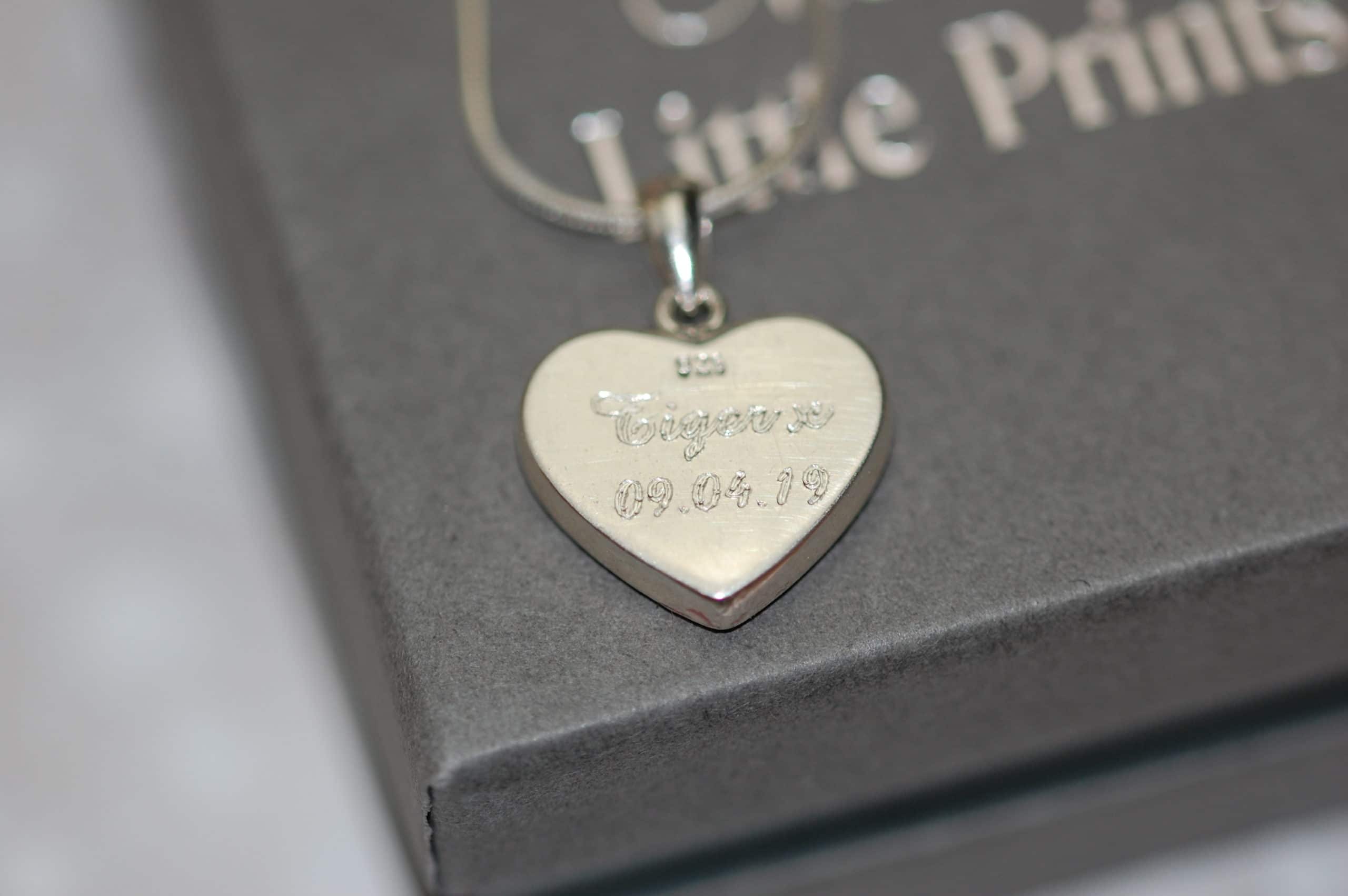 Pet name and date engraved on the back of silver heart pendant with pet fur or cremation ashes
