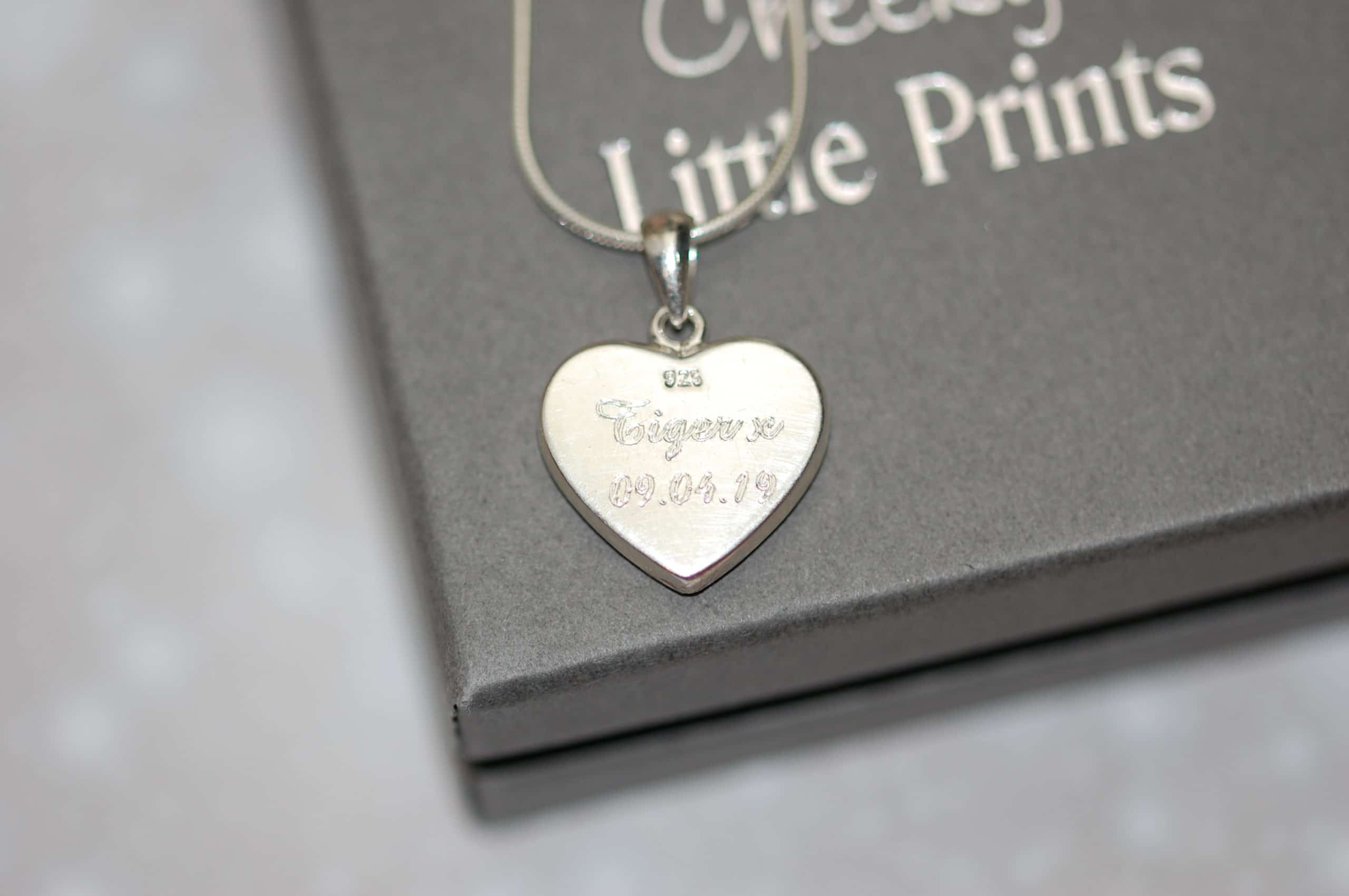 Pet name and date engraved on the back of silver heart pendant with pet fur or cremation ashes