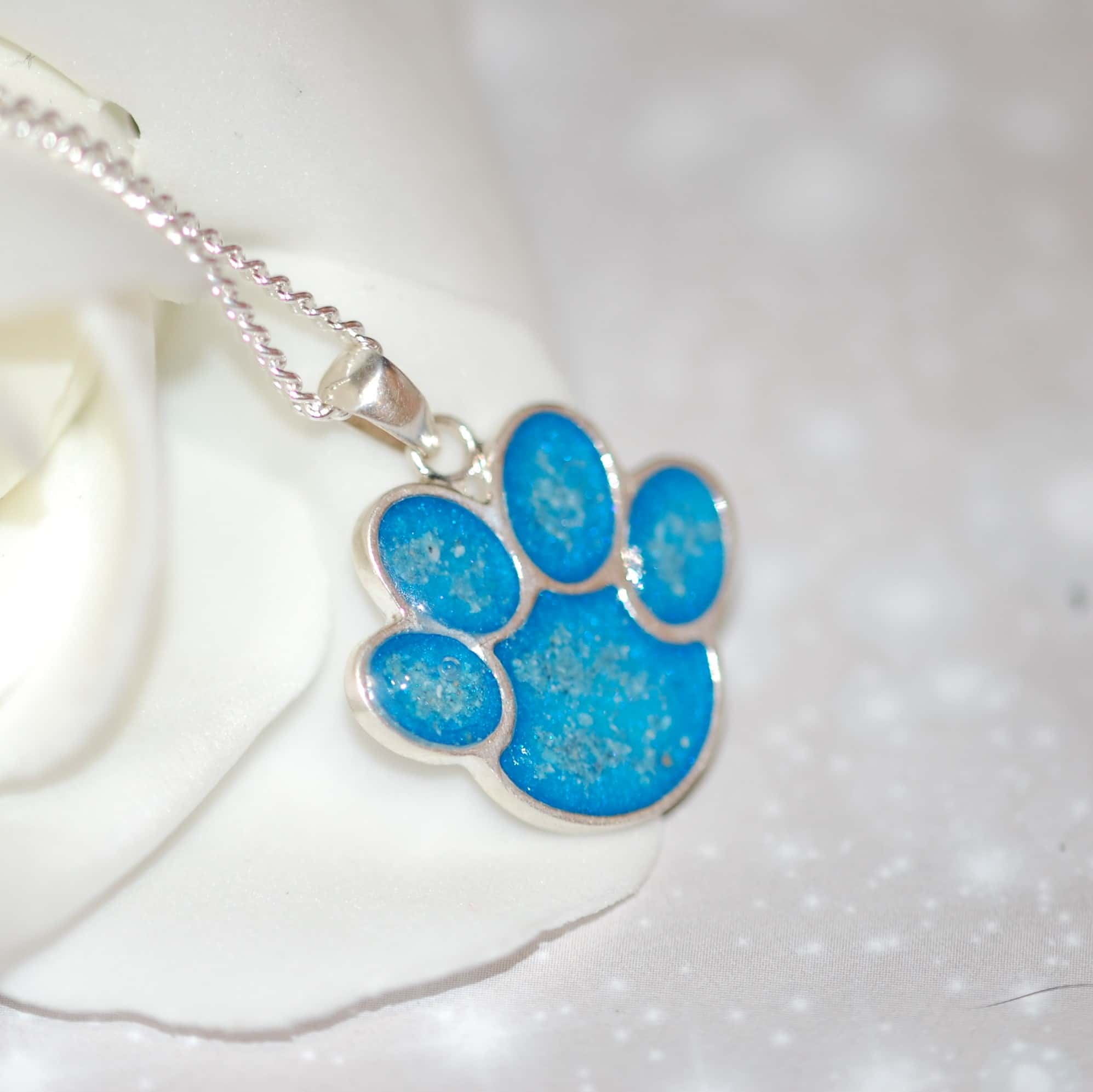 Silver paw print pendant with pet fur or cremation ashes