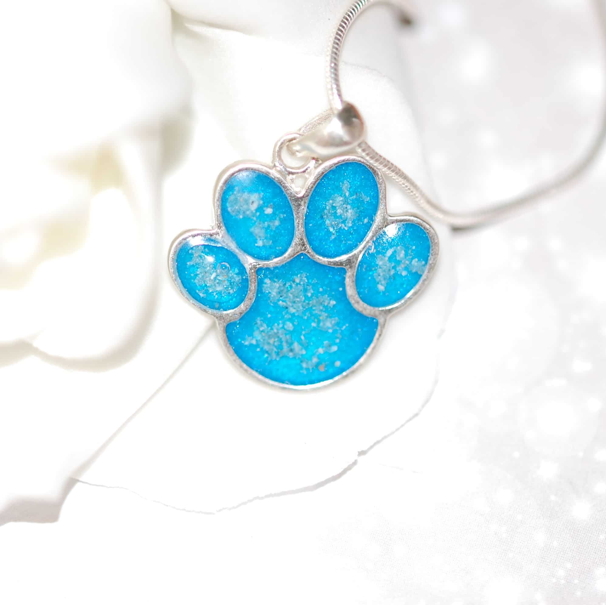 Silver paw print pendant with pet fur or cremation ashes