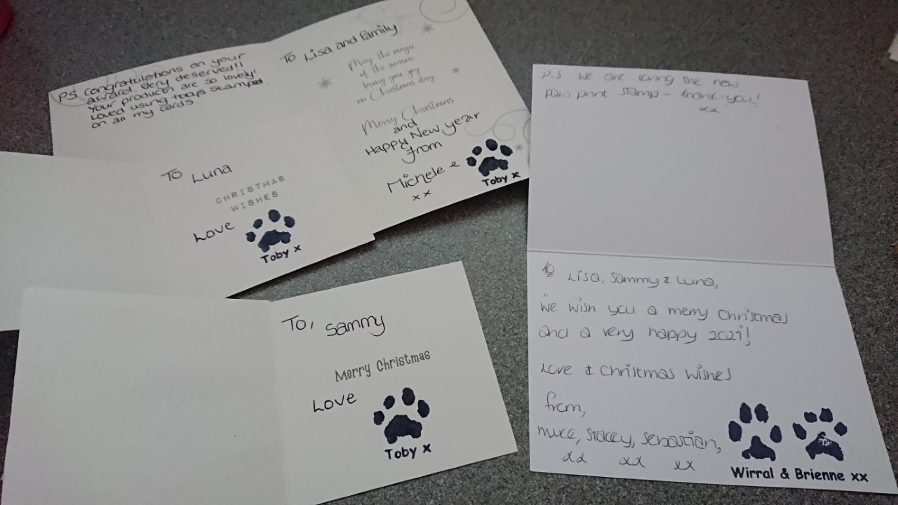 Customer Christmas cards with unique paw prints stamped inside using personalised stamps
