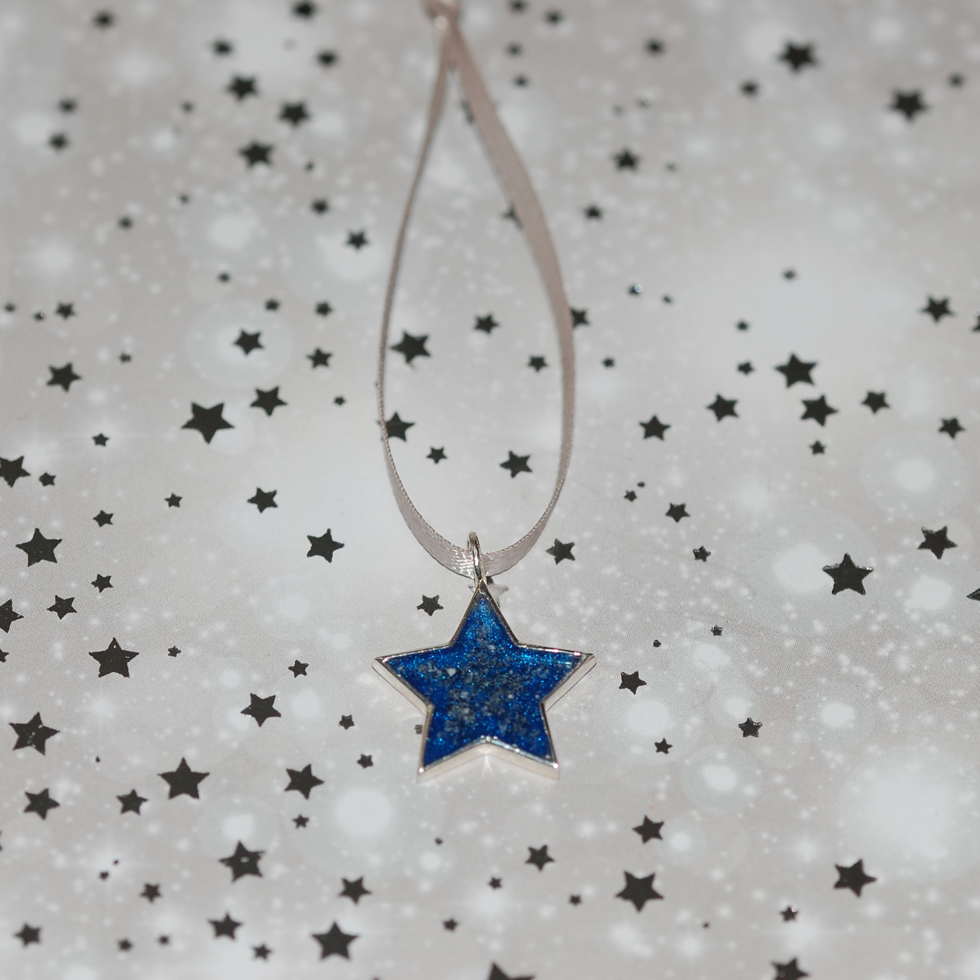 Silver star Christmas decoration with pet cremation ashes and blue resin