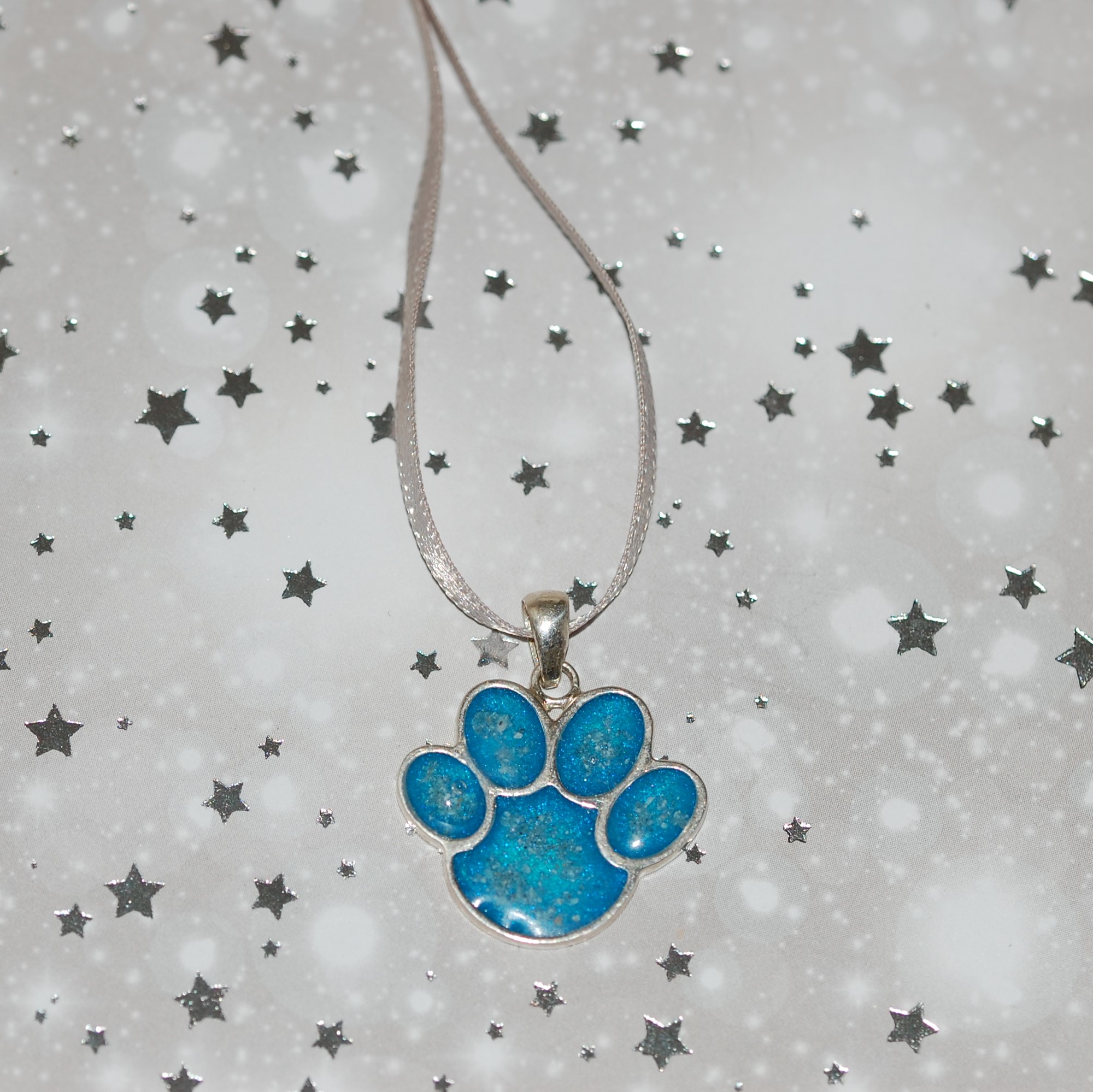 Paw print shaped personalised Christmas decoration with pet cremation ashes