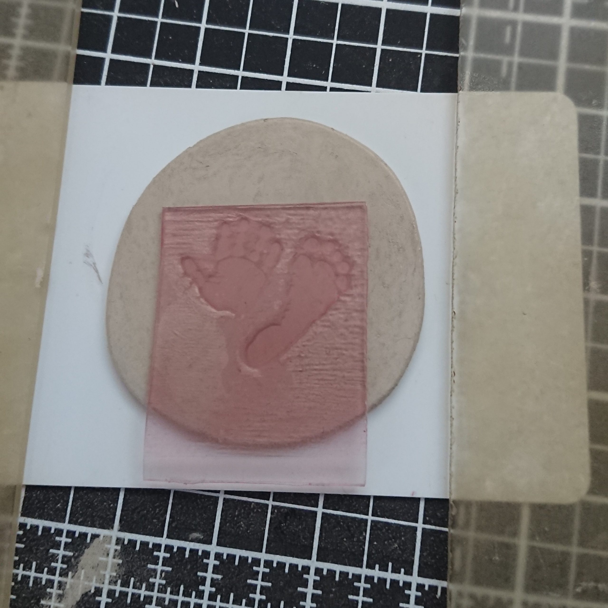 pressing hand and footprint stamp into silver clay